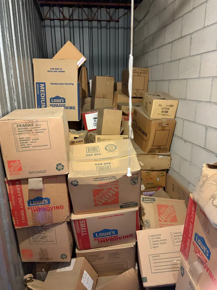 Storage unit packed with moving boxes before a cleanout